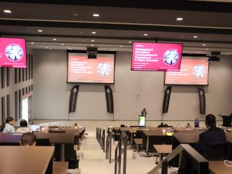 A large classroom in a modern building on a college campus.