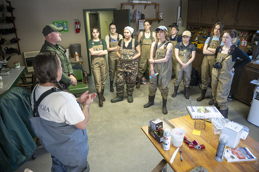 Female students listening to a male and female Georgia DNR employee