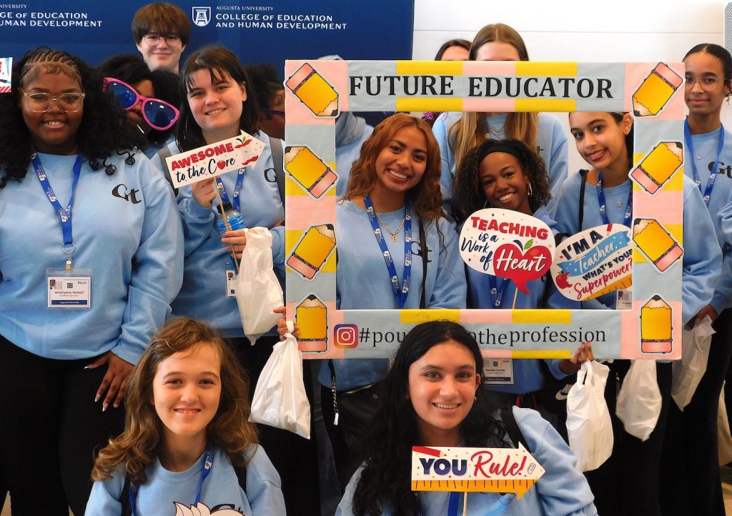 Students holding sign
