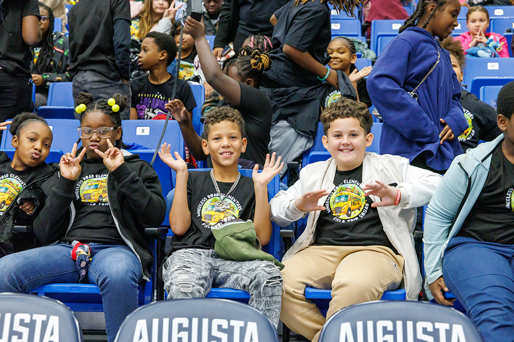 Boys and girls posing for photos