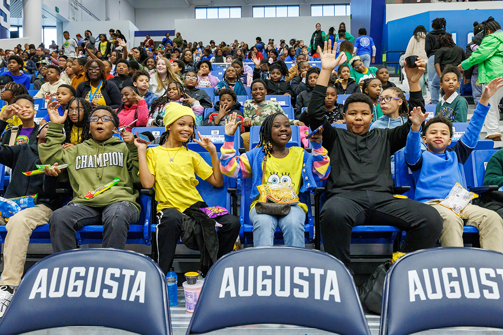 Boys and girls cheering in the stands