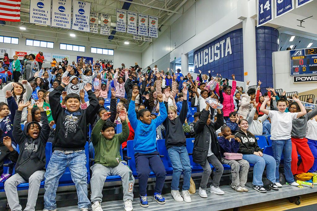 Students waving their arms in the air