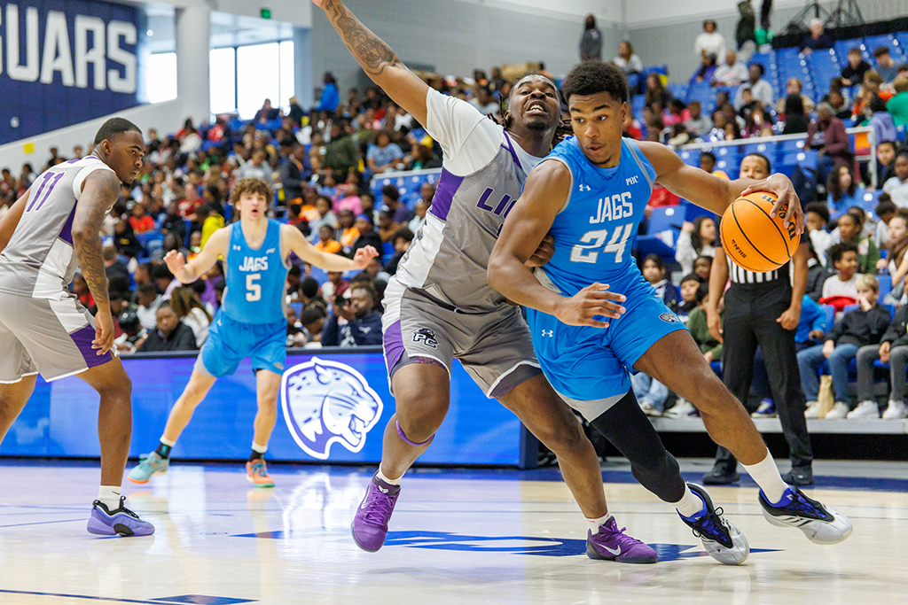 Two basketball players competing in a game