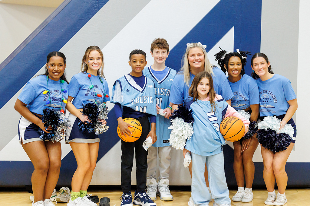 Boys and girls posing with cheerleaders