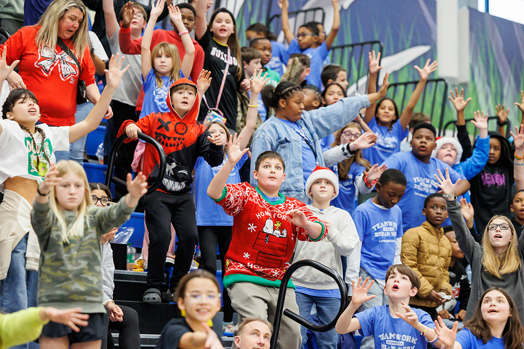 Boys and girls watching T-shirts fly into the stands