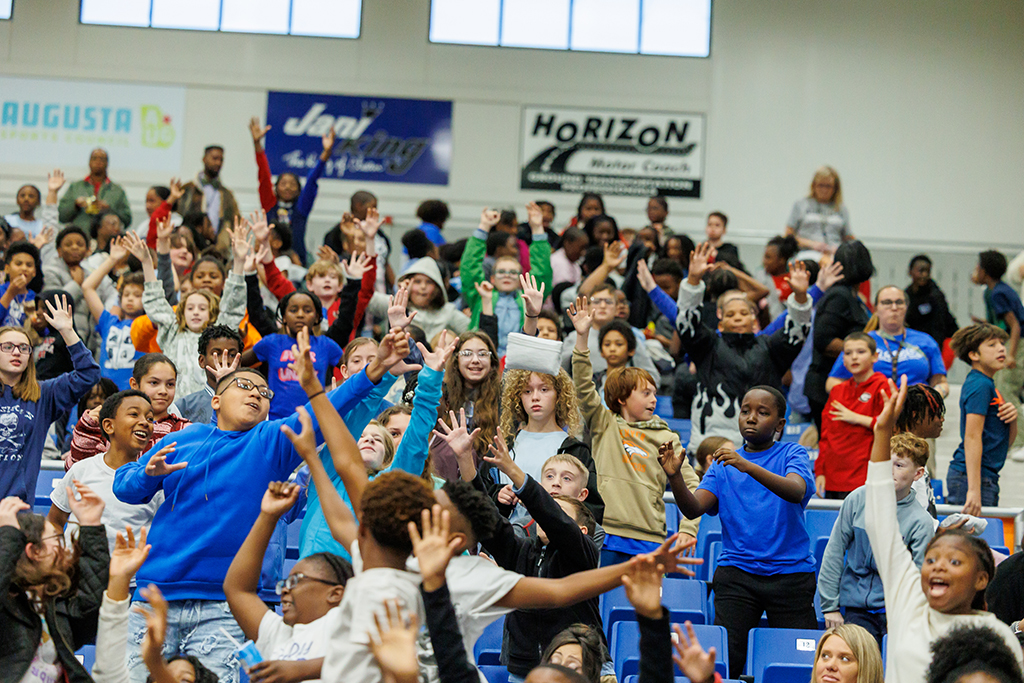 Boys and girls cheering in the stands