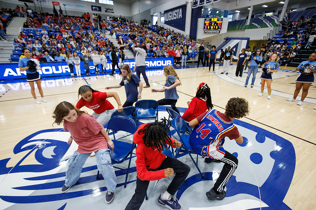 Boys and girls playing Musical Chairs on the basketball court
