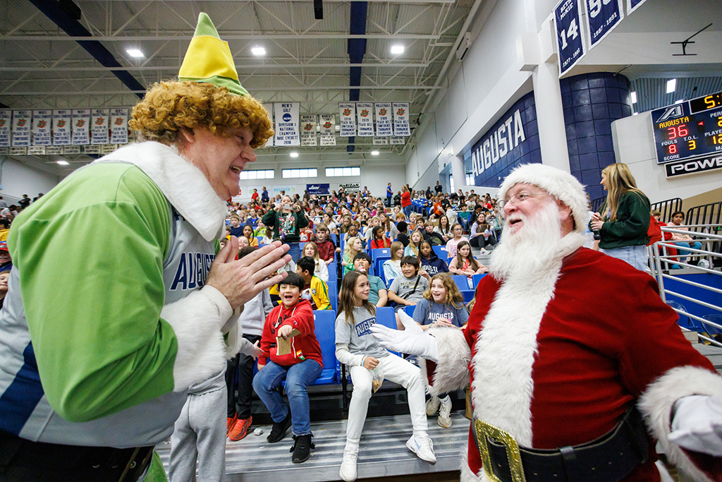 "Buddy the Elf" and Santa Claus meet in front of students