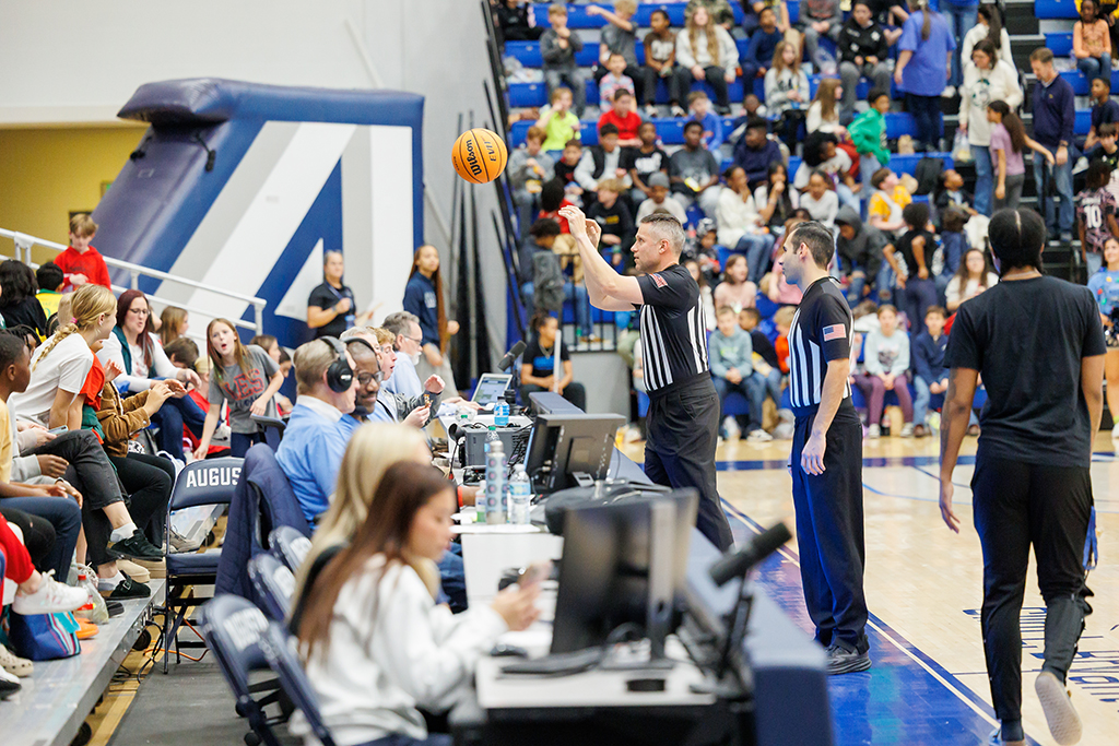Referees throwing the ball to students
