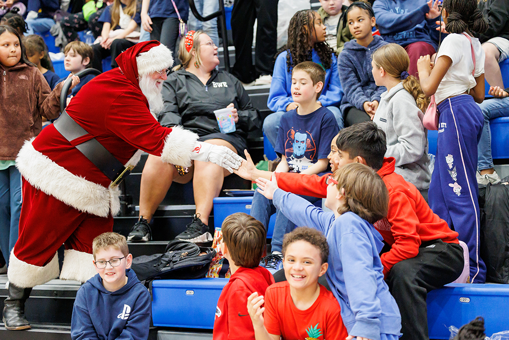 Santa Claus greeting students in the stands