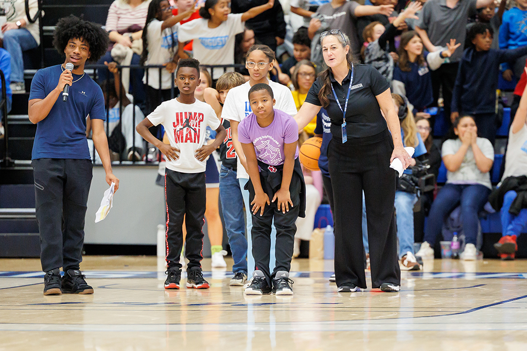 Men and women helping students play a contest