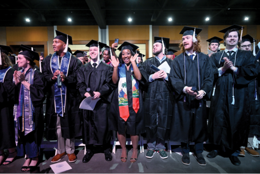 Graduates pose together in their regalia.