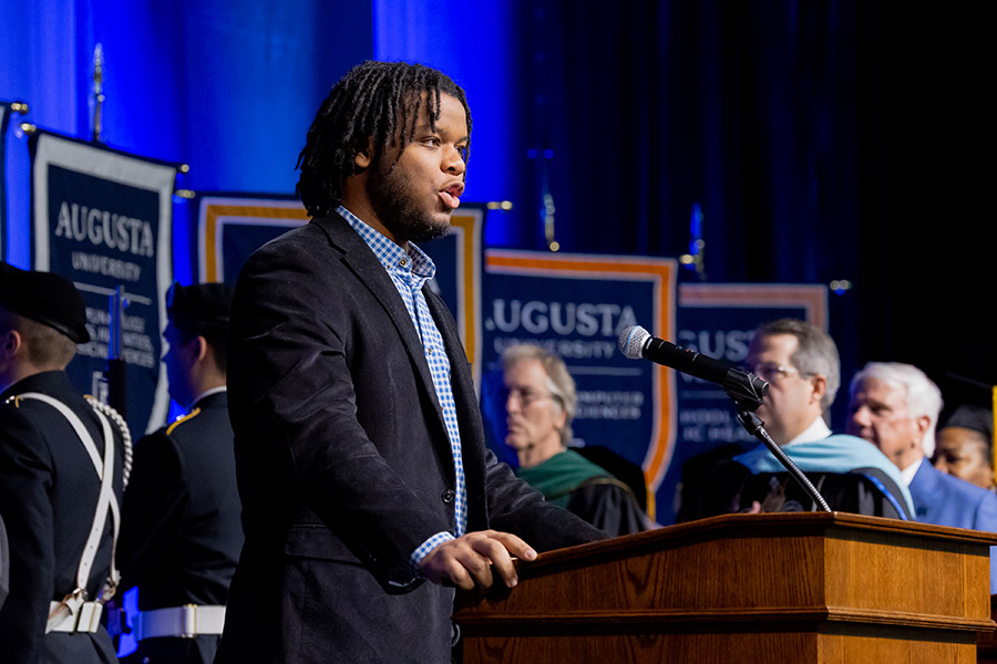 man singing at a podium. 
