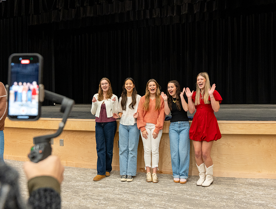 A group of high school girls pose for a photo.