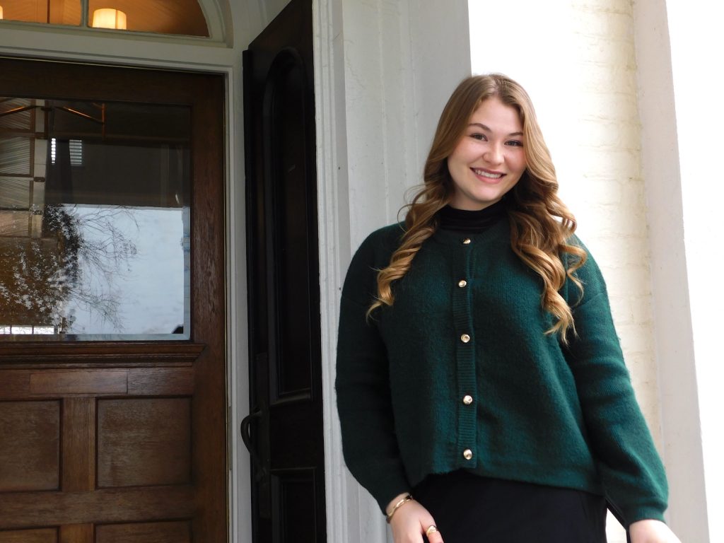 Woman standing in front of a building.