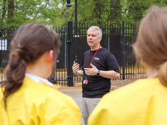 A man speaks to a group of health care trainees.