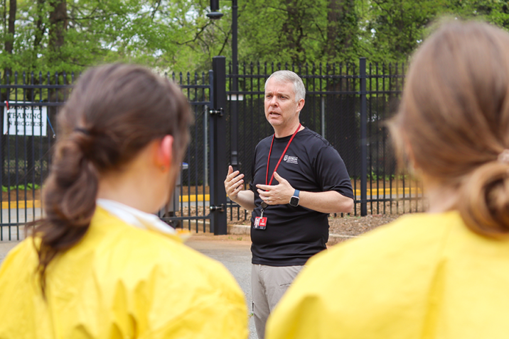 A man speaks to a group of health care trainees.
