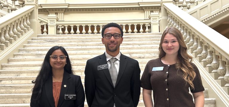 Three students in the Capitol.