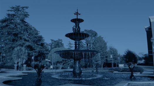 A large fountain on a college campus.