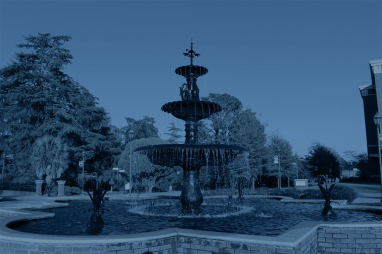 A large fountain on a college campus.