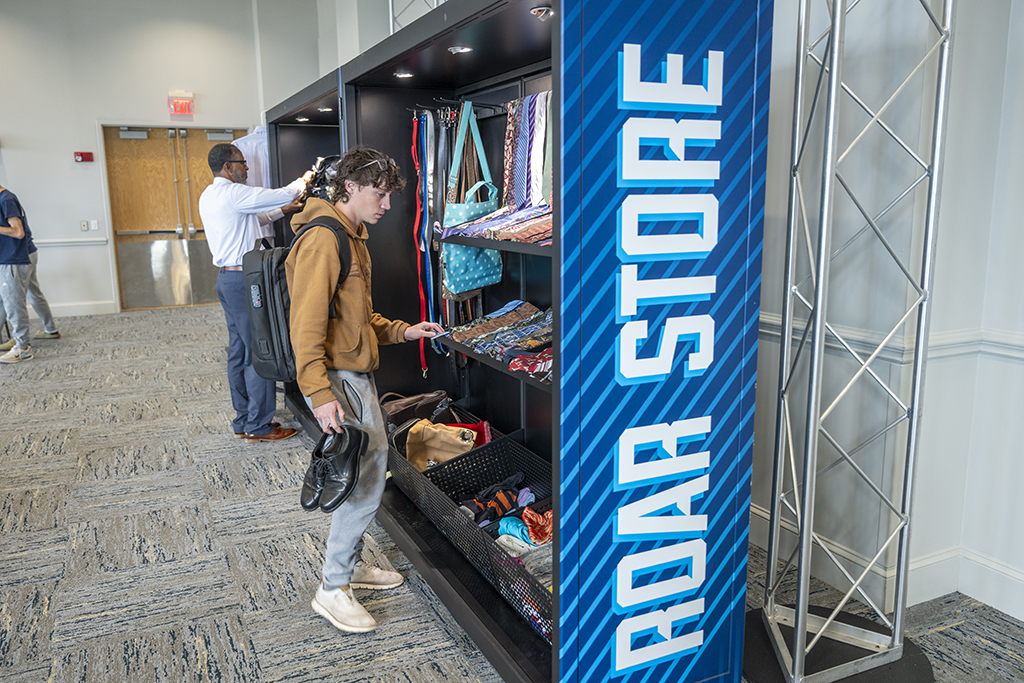 A man looking at shoes and ties