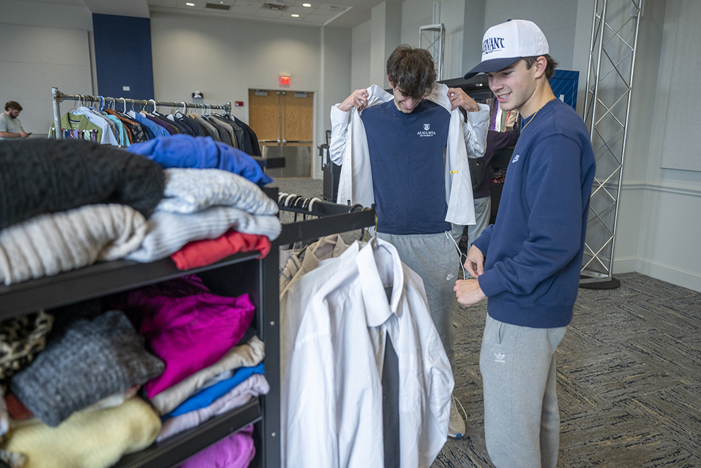 Two men looking at clothing