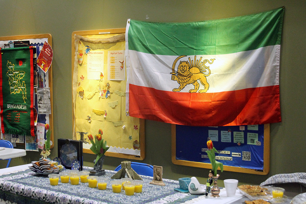 Food sitting on a table in front of a flag