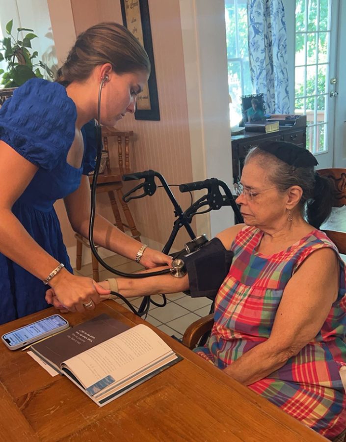 Two women together taking blood pressure