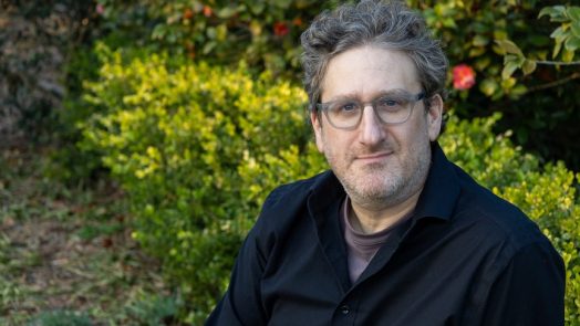 man with glasses smiling