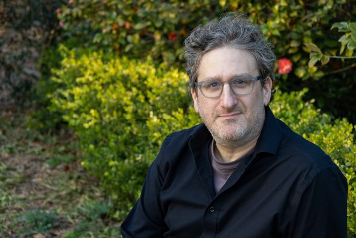 man with glasses smiling