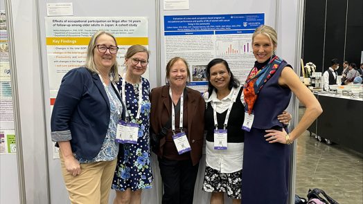 Five women standing in front of a poster