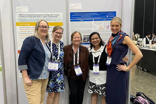Five women standing in front of a poster