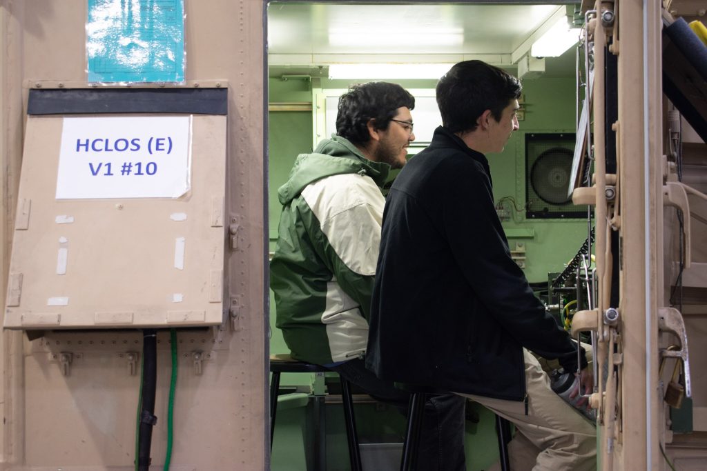 Students sitting in military room.