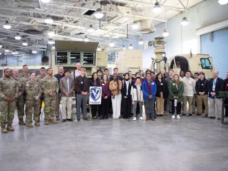 Students in a group with soldiers inside a building