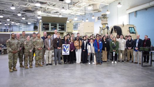 Students in a group with soldiers inside a building
