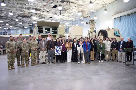 Students in a group with soldiers inside a building