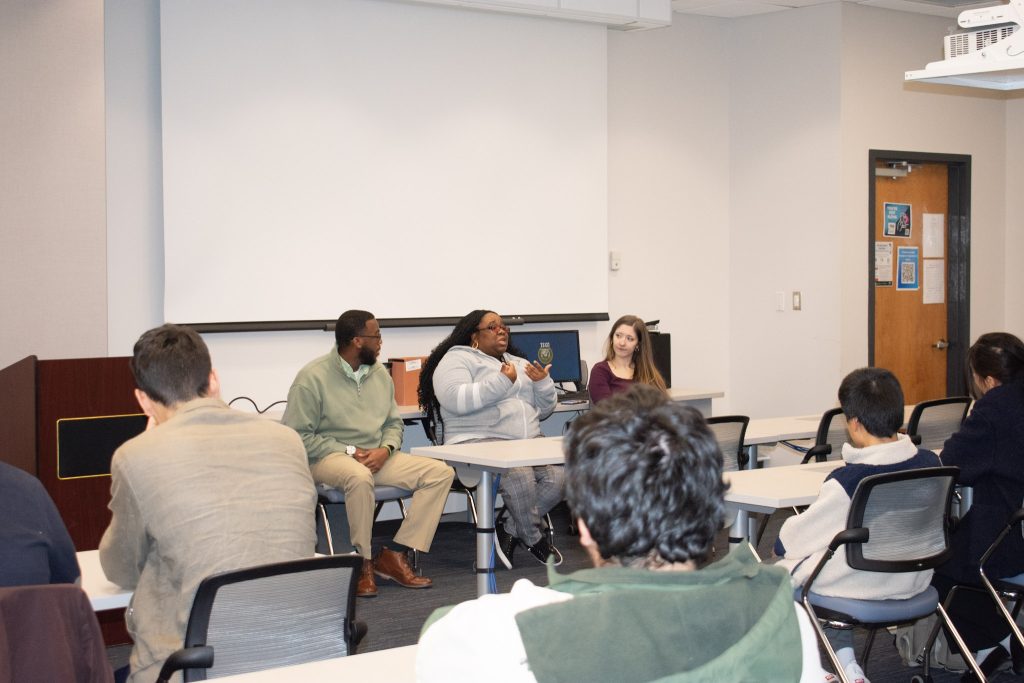 Students listening to speakers in classroom.