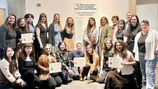 Men and women pose to take a photo