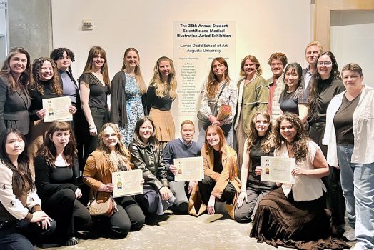 Men and women pose to take a photo