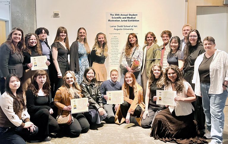 Men and women pose to take a photo