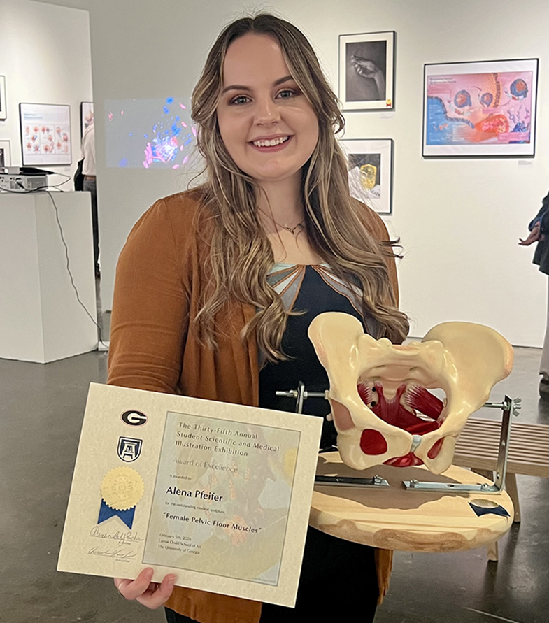 Woman holding a certificate in front of her winning display