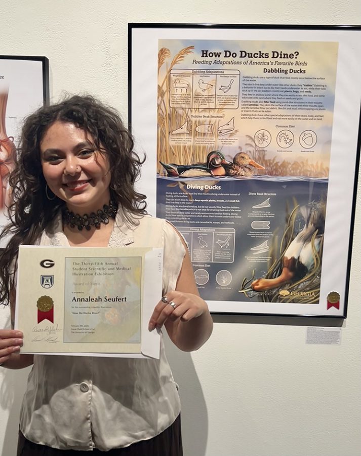 Woman holding a certificate in front of her winning display