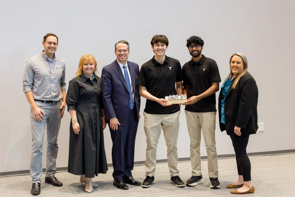 Group holding an award. 