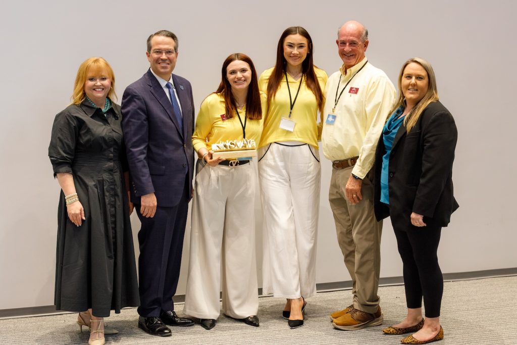 Group holding an award. 