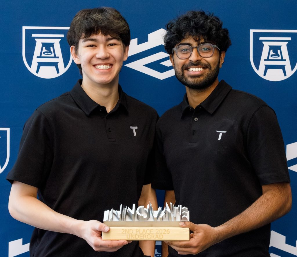 Two guys holding an award.