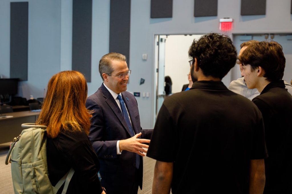 AU president talking with students