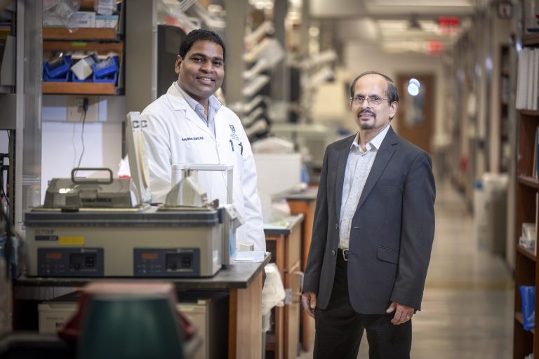 Two men standing in a research lab inside the Georgia Cancer Center's M. Bert Storey Research Building.
