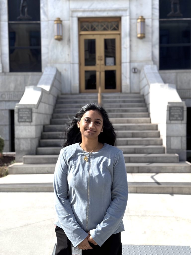 Woman standing in front of a building.