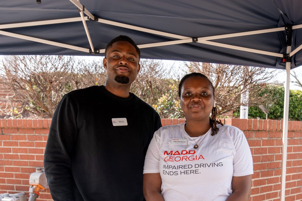 Two representatives from MADD standing underneath an outdoor tent.
