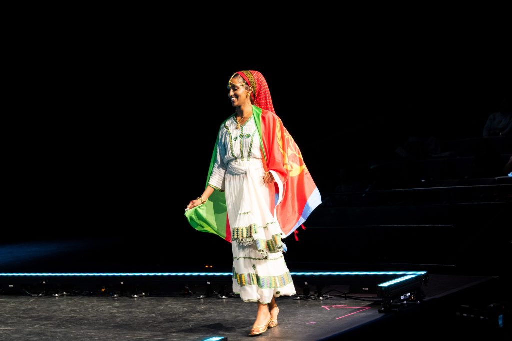A woman, mid turn, walks a runway